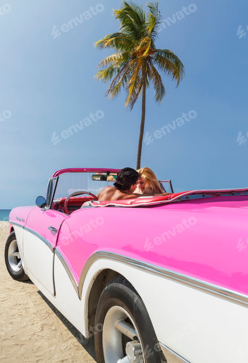 Preview: Couple in Convertible on beach