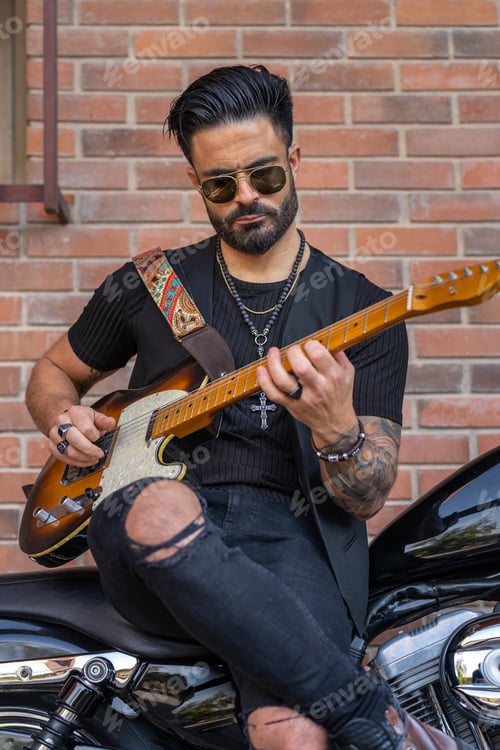 Preview: Man Plays Guitar Leaning on Motorcycle Outdoors