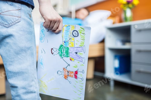 Preview: little son showing sick father his drawings at ward, dad and son