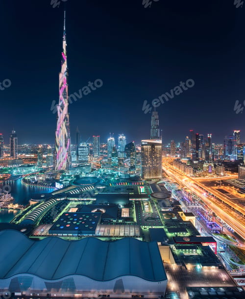 Preview: Cityscape of Dubai, United Arab Emirates at dusk, with illuminated Burj Khalifa skyscraper in the