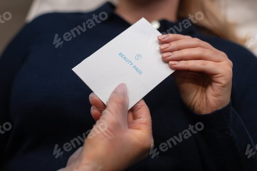 Preview: Cosmetologist girl professional gives beauty passport document to patient after procedures