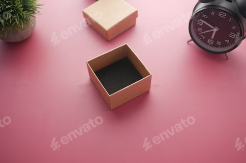 Preview: top view of person open a empty small gift box