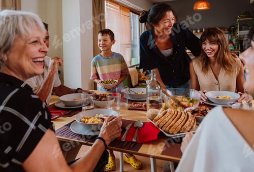 Preview: Family and friends reunion at home. Happy multigenerational family enjoying meal together at home