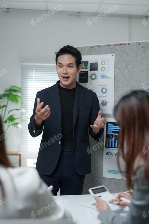Preview: Asian businessman leading meeting, explaining strategy to colleagues