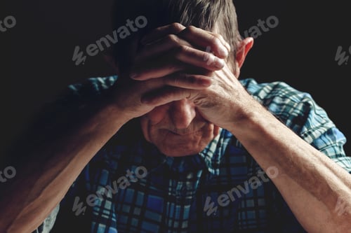 Preview: Depressed senior covers his face with his hands. Alzheimer's dis