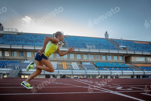 Preview: Young female sprinter athlete in the athletics stadium.