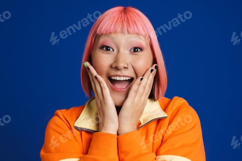 Preview: Asian girl with pink hair and piercing expressing surprise at camera