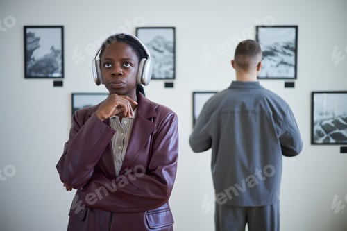 Preview: Contemplating Art in Modern Gallery with Headphones
