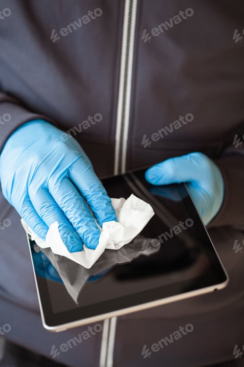 Preview: man hands in gloves disinfecting tablet computer screen, eliminate germs coronavirus bacteria
