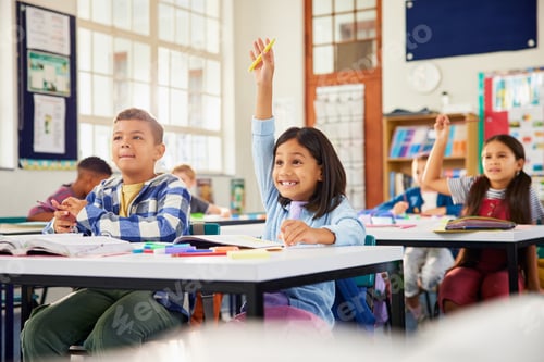 Preview: Girl raising hand in classroom: she knows the answer!