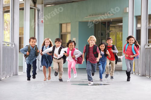 Preview: Group of elementary school kids running in a school corridor