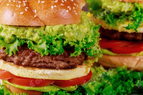 Preview: Homemade tasty grilled burger with eggs bun, beef patty, guacamole cutting board