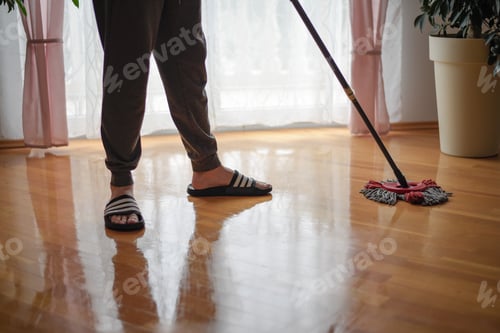 Preview: Closeup shot of a person cleaning the floors of the house