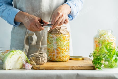 Preview: The preparation process fermentation preservation Sauerkraut on a light background. Natural rustic