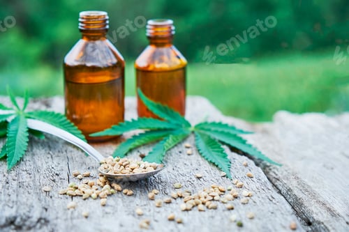 Preview: hemp leaves on wooden background, seeds, cannabis oil extracts in jars
