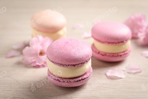 Preview: Pink macarons and flowers on white wooden table