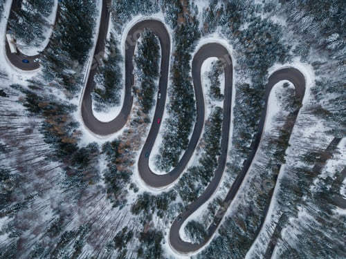 Preview: Aerial top down view of winter winding road in the forest, Transylvania, Romania.