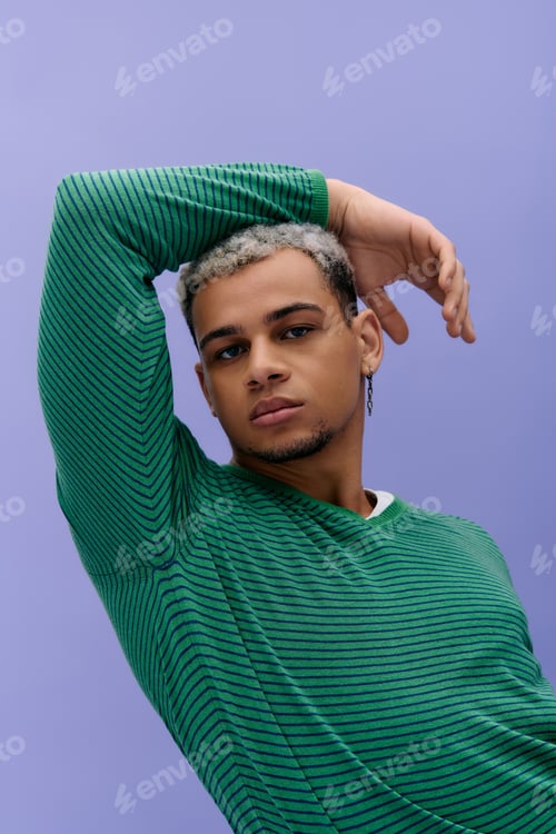 Preview: A young man's bold fashion stands out against a vibrant purple backdrop