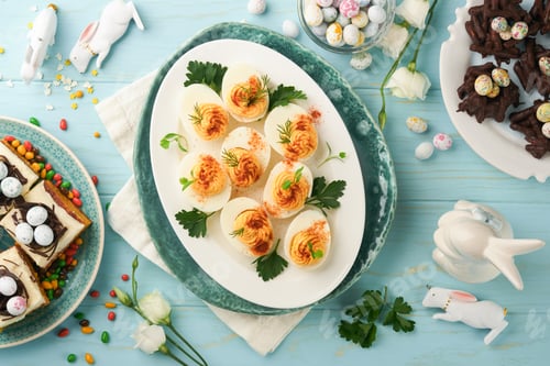 Preview: Traditional Easter brunch or dinner with stuffed eggs with paprika, carrot cake bars and chocolate n