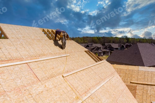Preview: Workers build a roof on the house applying roof plywood panels