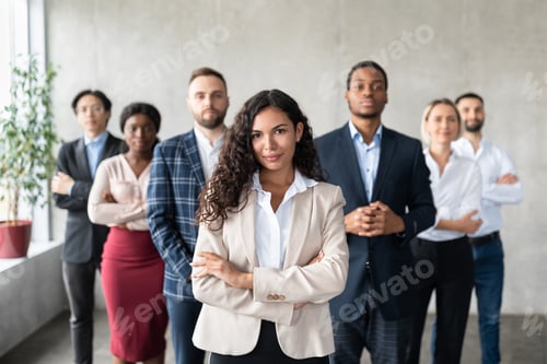 Preview: Successful Businesswoman Standing In Front Of Business Team In Office