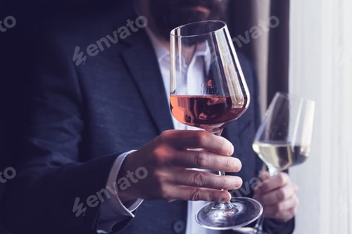 Preview: man offering a glass of rose wine