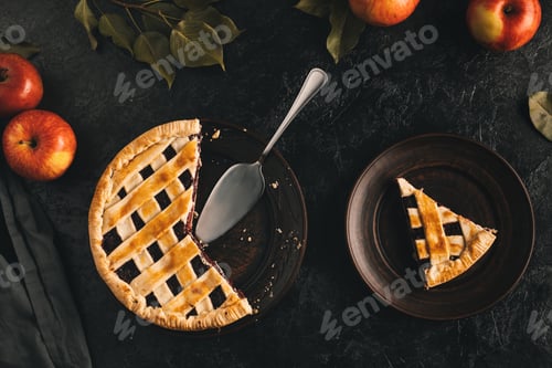 Preview: flat lay with arranged apple pie with cake server and fresh apples isolated on black surface