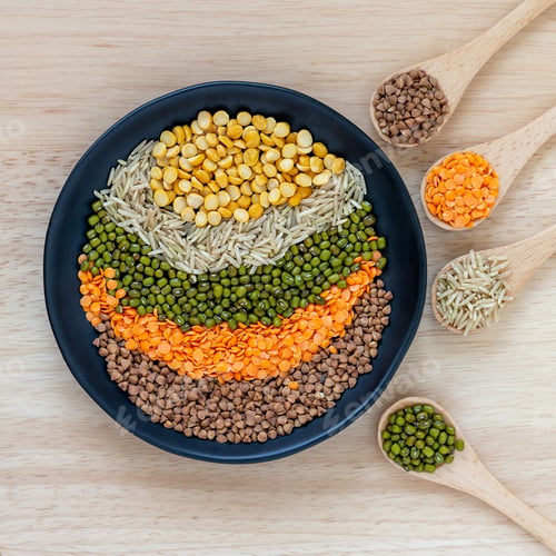 Preview: Different grains in the black bowl and in wooden spoons: rice, moong beans, dal and buckwheat