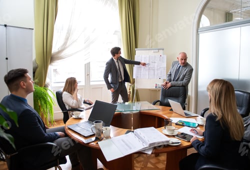 Preview: Professionals Gather for Business Presentation in Boardroom