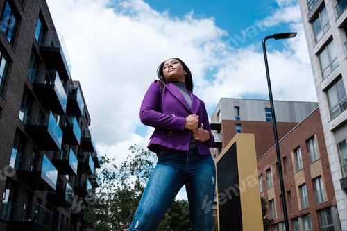 Preview: Portrait of mixed race woman model posing in a street of London.