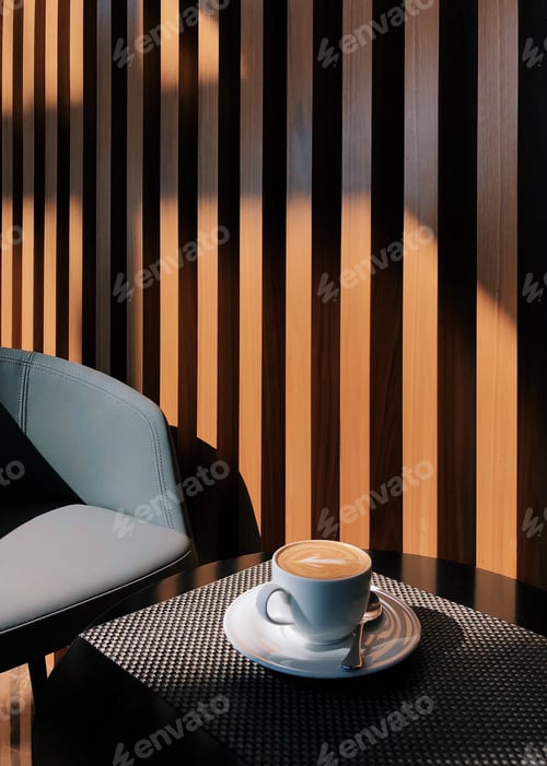 Preview: Cup with coffee on the table at sunny day