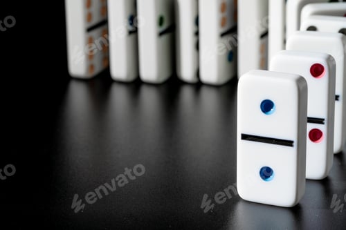 Preview: Dominoes standing in a row on black background