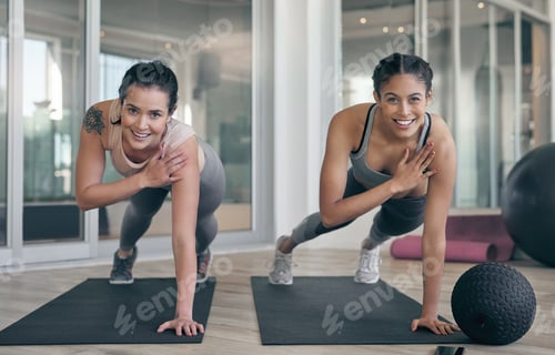Preview: Shot of two young athletes working out together at the gym