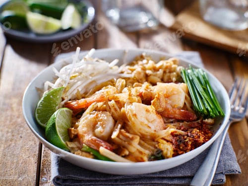 Preview: shrimp pad thai on plate with chives and peanuts