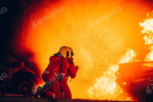 Preview: Fearless Firefighters Battling Blaze with Water and Extinguishers.