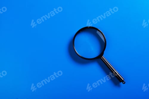 Preview: Magnifier on blue background close up
