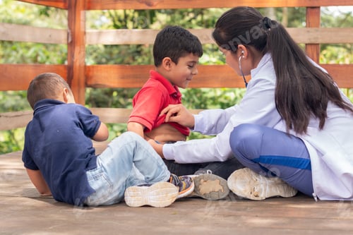Preview: The doctor attends to two children in a playground so they can enjoy their visit to the doctor.