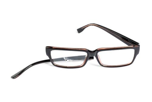 Preview: Eyeglasses with one broken lens isolated on white