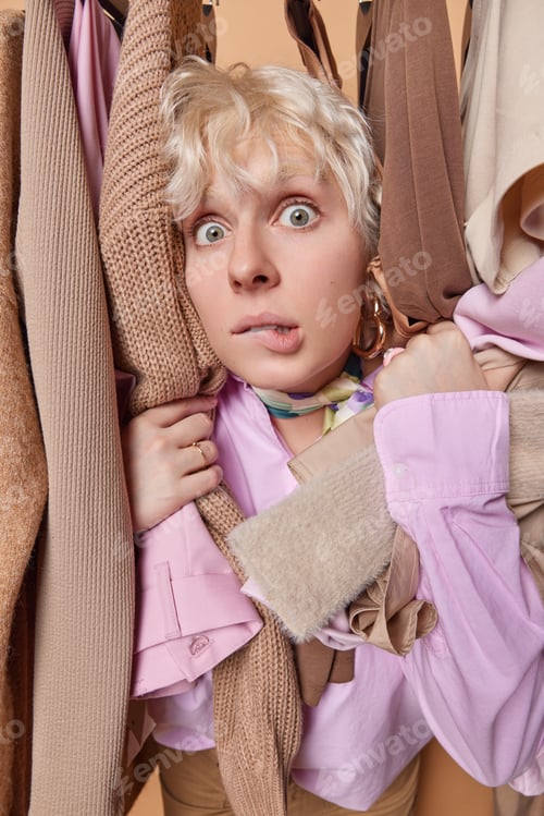 Preview: Photo of European female buyer surprised as if seeing something unusual or unexpected standing over
