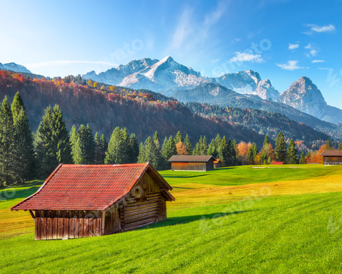 Preview: Fabulous view of alpine meadow with wooden huts near Wagenbruchsee (Geroldsee) lake