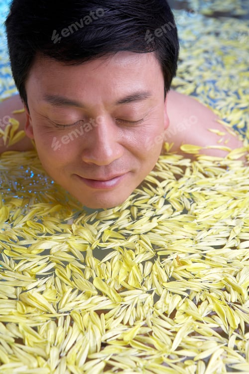 Preview: Man relaxing in a flower bath