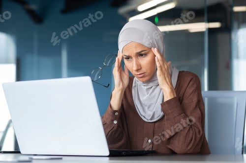 Preview: Tired business woman working at workplace inside office, Muslim woman with hijab is sick with