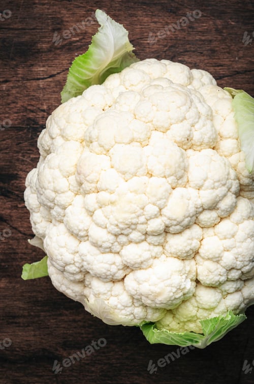 Preview: Fresh organic white cauliflower cabbage on old rustic wooden kitchen table background, top view