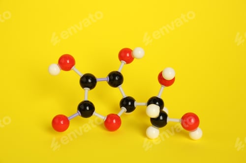 Preview: Molecule of vitamin C on yellow background. Chemical model
