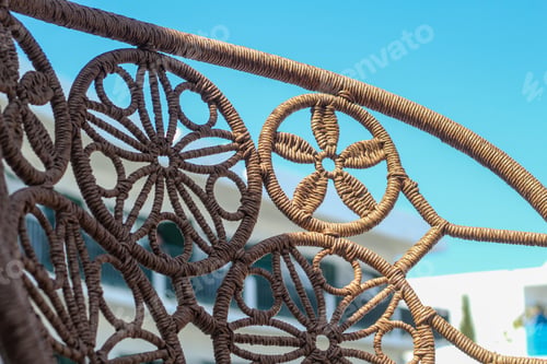 Preview: back of a wicker chair on the terrace of a Greek hotel.