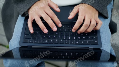 Preview: Student hands working keyboard outdoor closeup. Unknown man typing laptop device