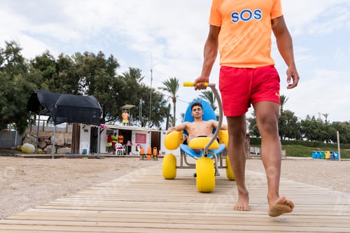 Preview: lifeguard carrying an injured man on the beach