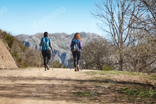 Preview: Two female backpacker walking on a pathway. Mountain trekking
