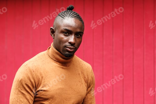 Preview: Relaxed male model looking at camera outdoors.