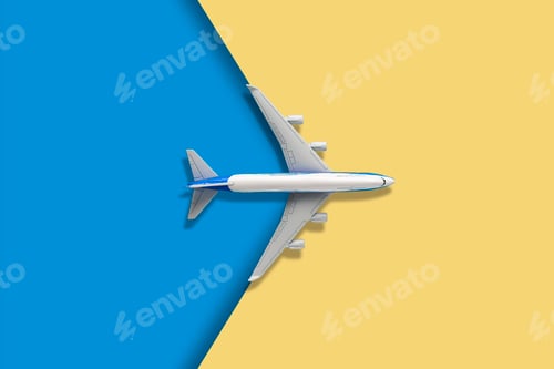 Preview: a top view of a plane on a two color backgroind creative travel concept and copy space